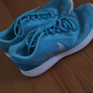 Blue Nike revolution 3 with shiny silver Check.